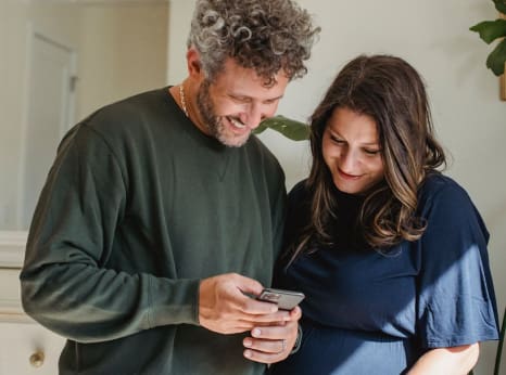 Older couple using a tablet together, illustrating digital tools for caregivers.